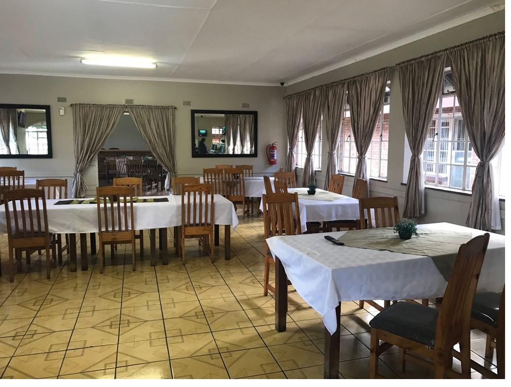 Dining hall with white-clothed tables