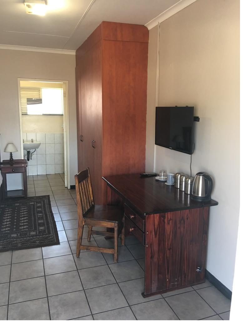 En-suite guest room with TV and desk